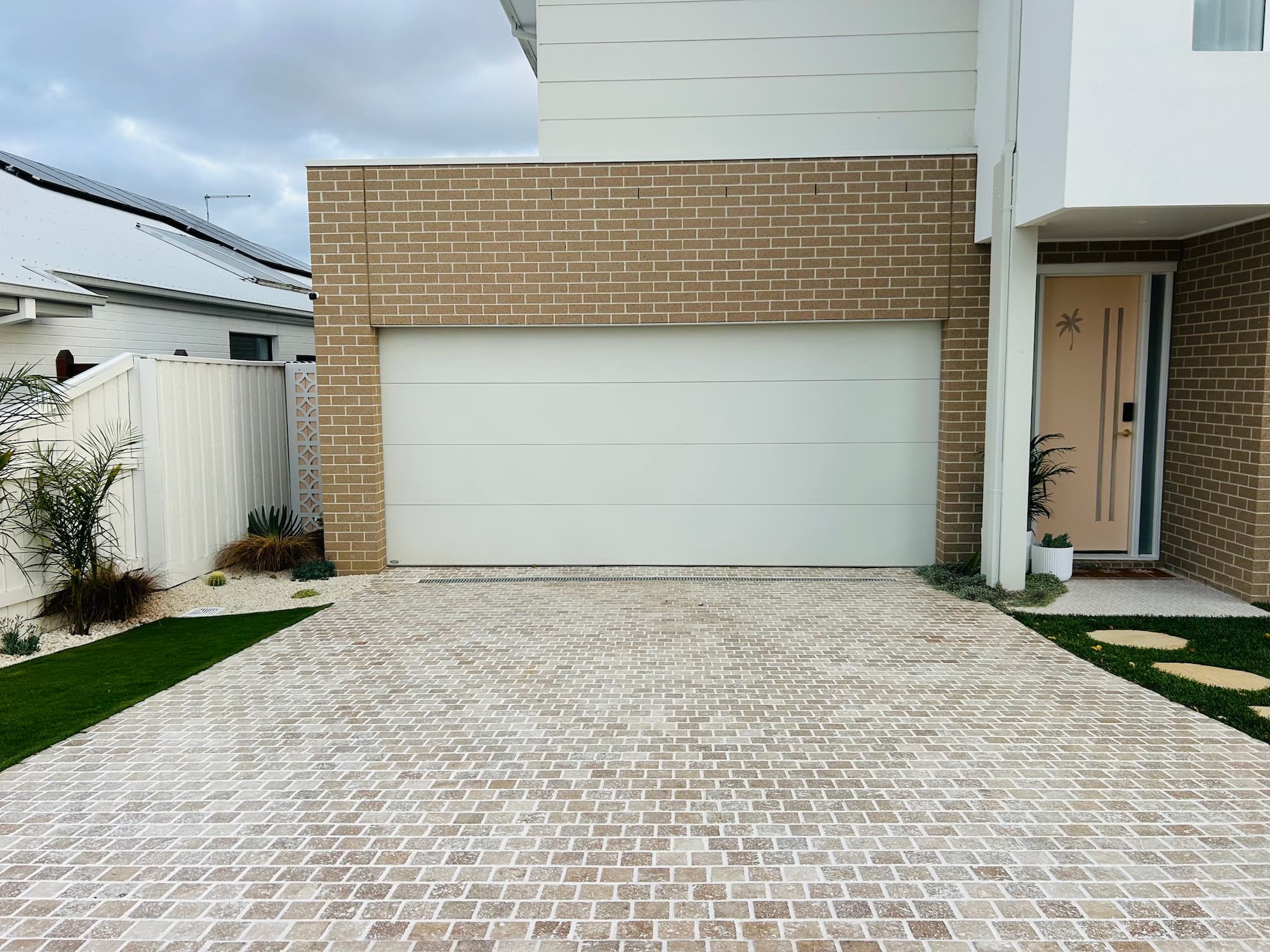 Finished front yard with cobblestone driveway and fresh turf by KO. Landscapes